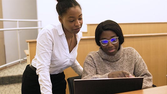 two-students-looking-at-computer